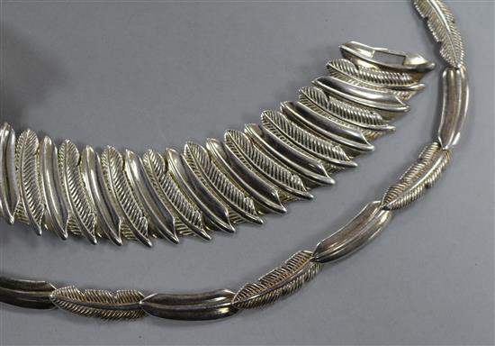 A contemporary silver feather necklace and matching bracelet.